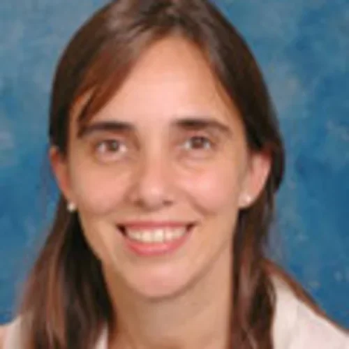 portrait of woman with brown hair against a blue background