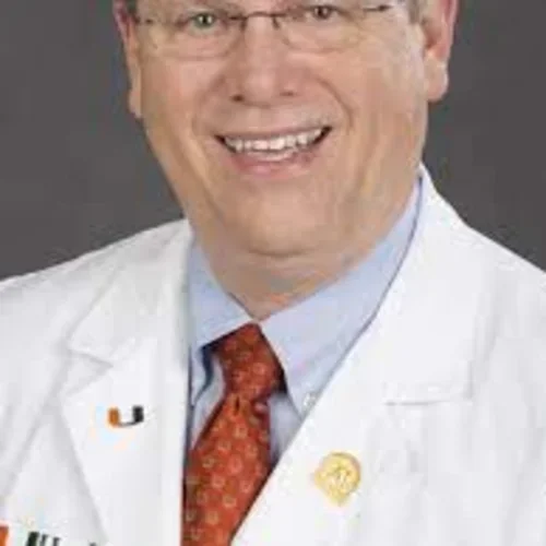 a doctor wearing a red tie and u miami pins