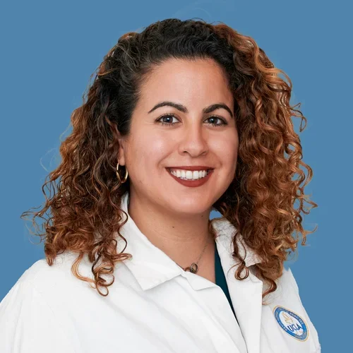 A doctor with curly brown hair